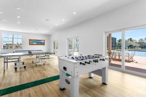 a room with two ping pong tables and a pool at Stone Park Ellsworth-Bar Harbor in Ellsworth
