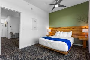 a bedroom with a large bed and a green wall at Stone Park Ellsworth-Bar Harbor in Ellsworth +42 photos