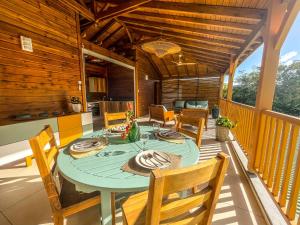 a dining room with a table and chairs on a deck at Bohème Chic, 2 Suites, Terrasse XXL in Le Gosier