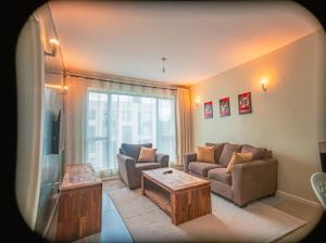 a living room with a couch and a coffee table at Easy Stay Rongai Poolside 2BR near Karen WiFi and Netflix in Ongata Rongai 