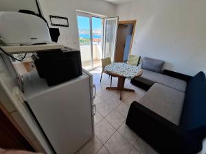 a living room with a couch and a table at MIRKO DIVING CENTER in Rab