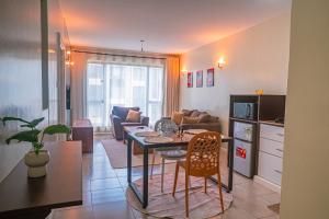 a kitchen and living room with a table and chairs at Easy Stay Rongai Poolside 2BR near Karen WiFi and Netflix in Ongata Rongai 