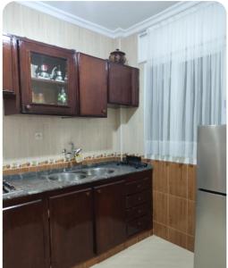 a kitchen with a sink and a refrigerator at Appartement vue mer à Fnideq in Fnidek