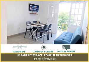 a dining room with a table and chairs at Chambre Carnaval Abymes Guadeloupe in Les Abymes