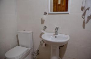 a white bathroom with a toilet and a sink at Elagza Dag Evi in Rize +38 photos