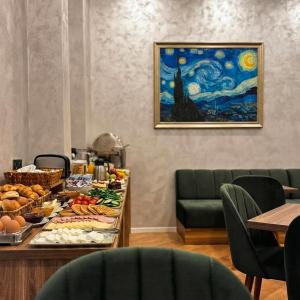 a table with food on it in a dining room at Zimmer Boutique Hotel in Baku