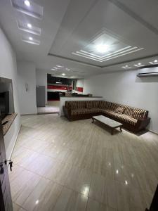 a living room with a couch and a table at Dyar Abdellatif in Kelibia