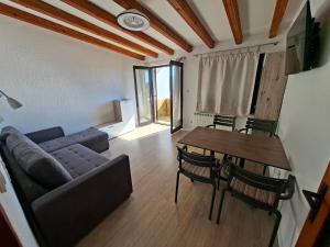 a living room with a couch and a table at MIRKO DIVING CENTER in Rab