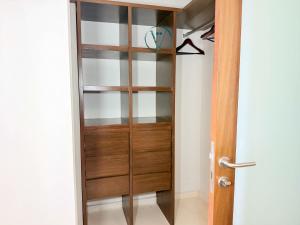 a wooden book shelf in a room with a door at Endless Ocean Views Luxury Bolongo Escape in Higuera Blanca