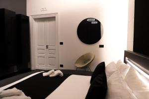 a bedroom with a bed and a chair in it at 115 Luxury Suite - Privitera in Grammichele