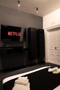 a living room with a netflix sign on the wall at 115 Luxury Suite - Privitera in Grammichele
