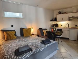 a bedroom with a large bed and a kitchen at Pension Schier in Zandvoort
