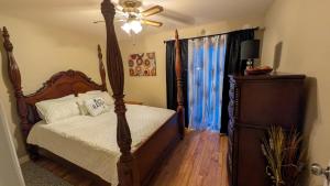 a bedroom with a bed and a ceiling fan at spacious three bedroom apartment in Bras D'or