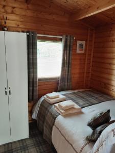 a bedroom with a bed in a wooden cabin at Emili Fois in Tore