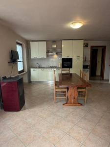 a large kitchen with a wooden table and chairs at Il Rustico di Calosso in Calosso +14 photos
