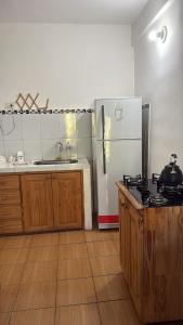 a kitchen with a stove and a refrigerator at Nathaly aparts iguazú in Puerto Iguazú