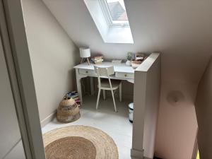 a small attic room with a desk and a skylight at La Dune Dorée Escapade Croteloise in Le Crotoy