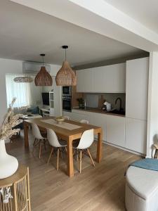 a kitchen and dining room with a table and chairs at La Dune Dorée Escapade Croteloise in Le Crotoy