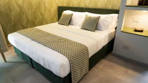 a bedroom with a large bed with white sheets and pillows at TubHotel in Grottazzolina +36 photos
