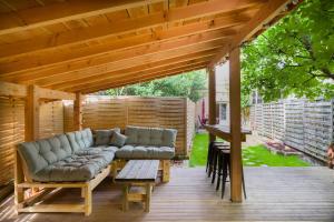a patio with couches on a wooden deck at Le Repaire d'Argenson in Bergerac