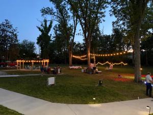 a group of people in a park with lights at Romantic Tea Cottage with Deck and Nature in Cape Girardeau