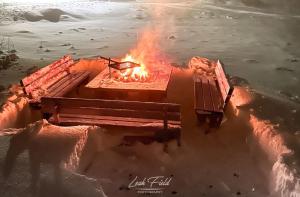 a fire pit in the middle of the water at Cozy cabin near the river in Kangos