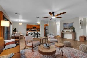a living room with a couch and a ceiling fan at Cactus Retreat Pool Fire Pit Pet Friendly in Green Valley