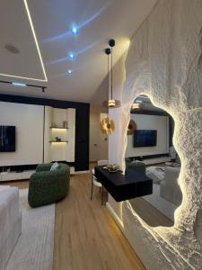 a living room with a couch and a table at Vluxuries in Lekki