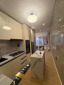 a kitchen with white cabinets and a counter top at Vluxuries in Lekki