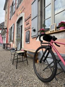 a pink bike parked in front of a building at La Maison de Laulie in Bagnères-de-Bigorre