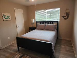 a bedroom with a large bed with a window at H20 paradise in Texas City