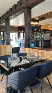 a restaurant with a table with wine glasses on it at Domaine Malar in Guillerval