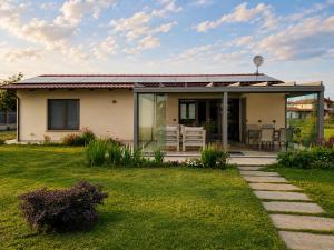 a small house with a patio and a lawn at Il Giardino di Sofia B&B in Piozzo