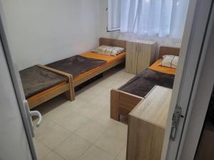 a room with two twin beds in a room at Apartman Terrazza in Igalo