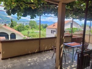 a view from the balcony of a house with a table at Apartman Terrazza in Igalo +3 photos