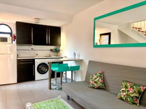 a living room with a couch and a kitchen at fuerte blue in Costa Calma
