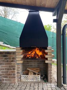 a brick oven with a fire inside of it at Chaloupka Jeřmanice in Jeřmanice