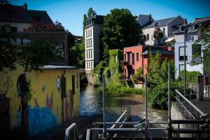 a view of a river in a city with buildings at Lindenau Inn in Leipzig