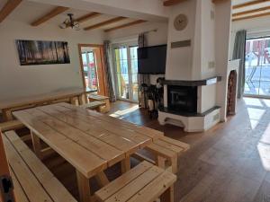a living room with a wooden table and a fireplace at Rekreační dům Štěpánka in Česká Kubice