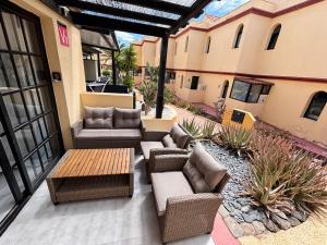 an outdoor patio with couches and a table and sidx sidx sidx at fuerte blue in Costa Calma