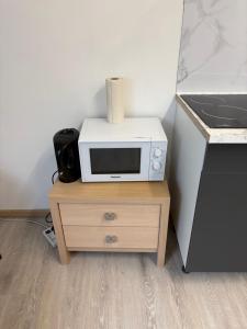 a microwave sitting on top of a wooden table at Studio in Geraardsbergen