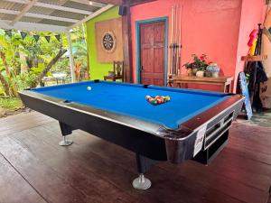 a pool table in a room with a pool at The Jungle Hotel and Bar in Bocas Town