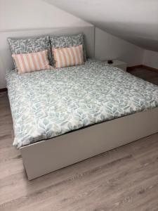 a bed in a room with a white bed frame at Studio in Geraardsbergen