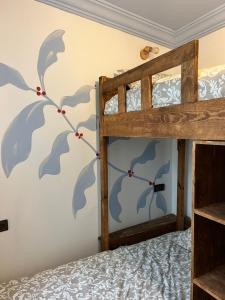 a bedroom with a bunk bed with a blue mural on the wall at windora essaouira in Essaouira