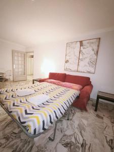 a living room with a bed and a couch at Appartamento Sole in Nice