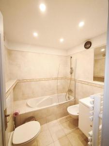 a bathroom with a tub and a toilet and a sink at Appartamento Sole in Nice +36 photos