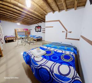 a bedroom with a blue and white bed in a room at Hacienda Hotel Colpa in Chincha