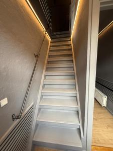 a staircase with white steps in a hallway at 4SEASONS - Amber Spring Suite in Aalborg