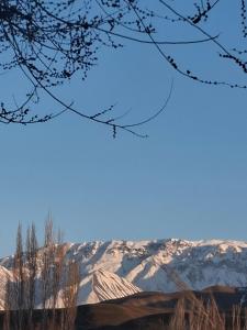 a view of snow covered mountains in the distance at Cozy Stay Emir in Kazarman