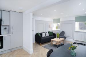 a living room with a couch and a table at Spacious 5BR - Heart of Galashiels -Group Friendly in Galashiels +17 photos